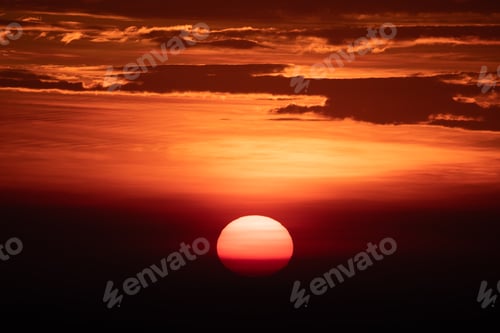 Vista previa: Beautiful sunrise and sunset at horizon against orange sky with clouds with no people