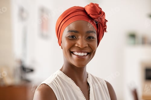 Preview: Smiling mature black woman with african headscarf