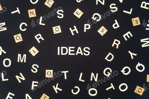 Preview: IDEAS word written on dark paper background. IDEAS text for your concepts