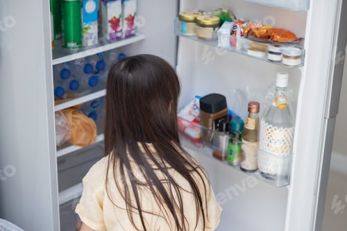 Preview: Girl opening refrigerator in kitchen