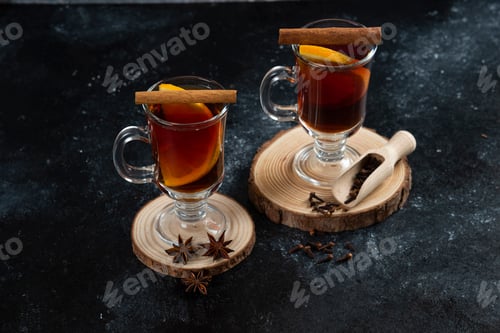 Preview: Two glass cups with tasty tea and cinnamon sticks