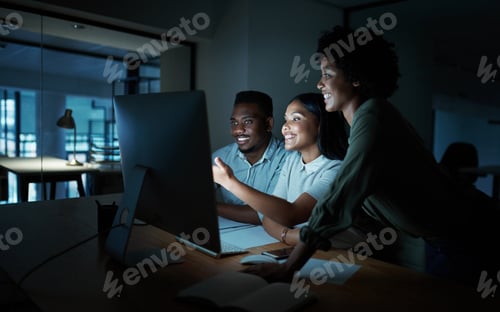Preview: Shot of a group of young businesspeople using a computer together during a late night at work