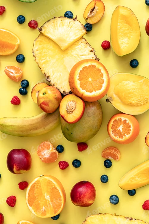Preview: Tropical fruits and berries on a yellow background, flat lay.
