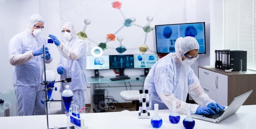 Preview: Team of scientist in protection equipment working in a modern research laboratory