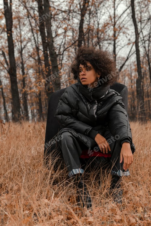 Preview: Beautiful Girl With Curly Hair In A Stylish Suit Walks Against The Backdrop Of A Beautiful Landscape