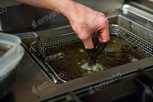 Preview: Cook holding the food in deep-fried boiling oil