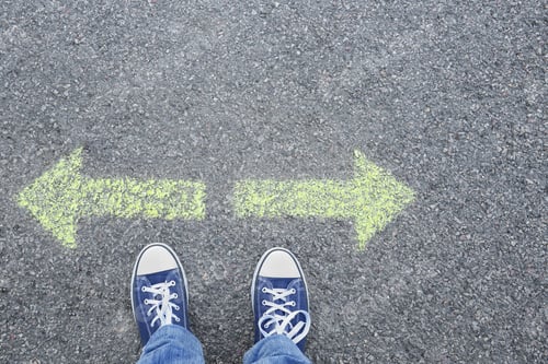 Preview: Man standing on road near arrows marking, closeup
