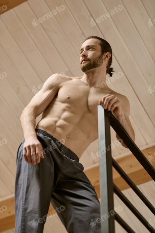 Preview: Balancing Act: Shirtless Man On Stair Rail