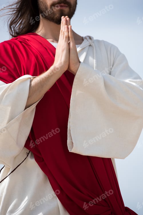 Preview: cropped image of Jesus in robe and red sash praying outdoors