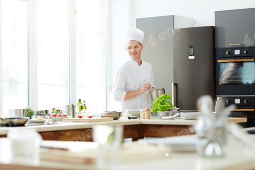 Preview: Smiling handsome cook at work