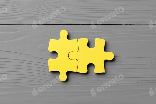Preview: Yellow puzzle pieces on gray background close up