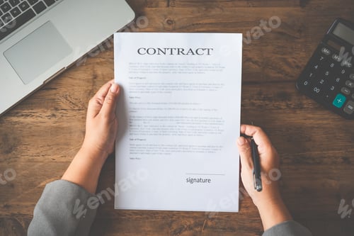 Preview: Hand holding pen signing contract in important documents.
