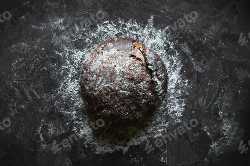 Preview: Black bread on a black background. homemade baking