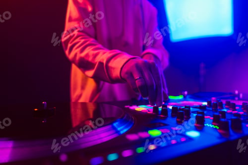 Preview: Hands of a DJ creating and regulating music on dj console mixer at club concert