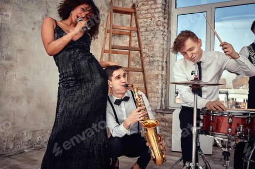 Preview: Repetition of multi ethnic jazz band in loft. Bass guitar player, electric guitar player