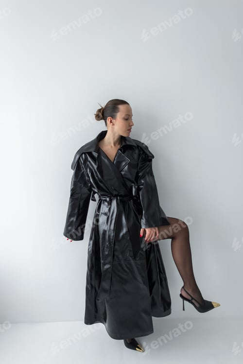 Preview: Confident woman in luxury black leather outerwear. Pretty sexy beauty girl in coat