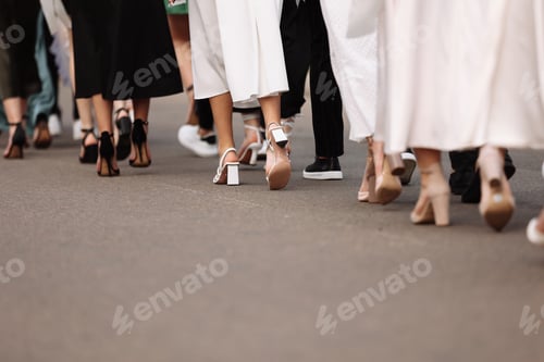 Preview: the feet of the group of people are walking outdoors. graduation day. stylish young guys and girls