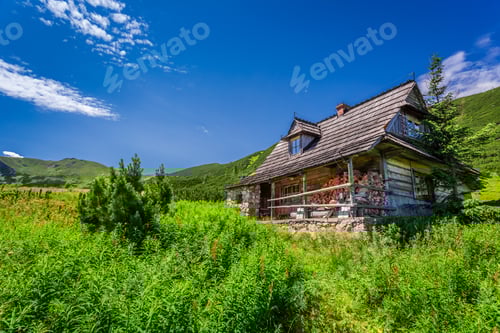 Preview: Small cottage in a mountain valley at sunrise