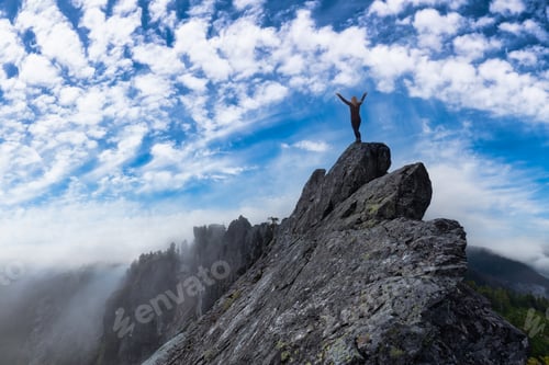 Preview: Adventurous Girl on top of a rugged rocky mountain