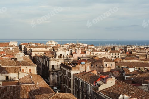 Preview: sunshine on buildings against blue sky in catania