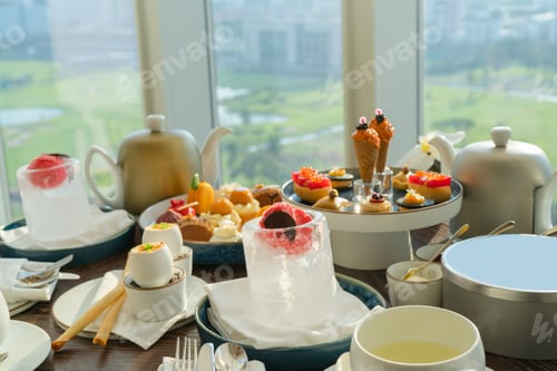 Preview: English afternoon tea, set beverages snacks desserts on table at restaurant