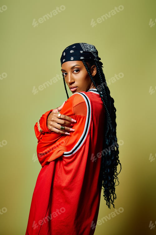 Preview: A young woman poses confidently, her long hair cascading down while wearing a bold outfit.