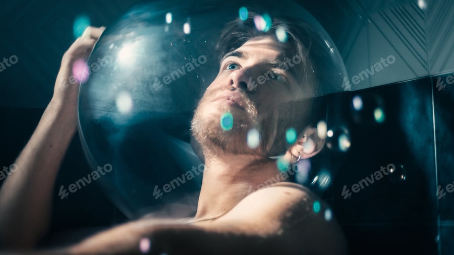 Cover for Thoughtful man alone wrapped in soap bubbles