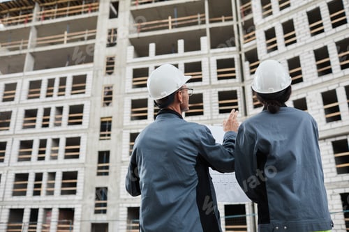 Preview: Workers Discussing Construction Plans