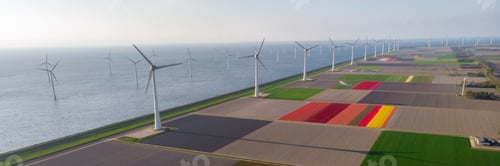 Preview: Windmill turbines at sea seen from a drone aerial view from above at a huge winmill park