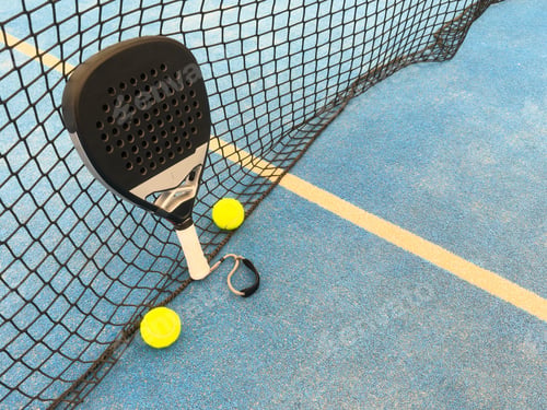 Preview: paddle tennis racket and balls on the blue paddle court