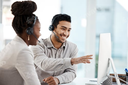 Preview: Love what you do. Shot of two colleagues working in a call center.