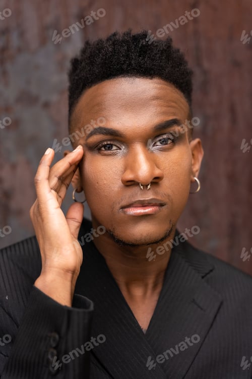 Preview: Portrait of a black ethnic man in a fashion pose on a metallic background with rust