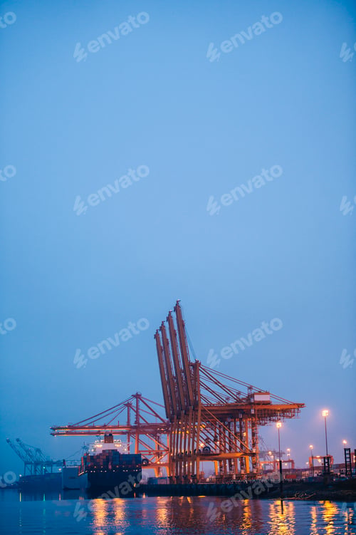 Preview: View of container ship and gantry cranes in harbor at night, Tacoma, Washington, USA