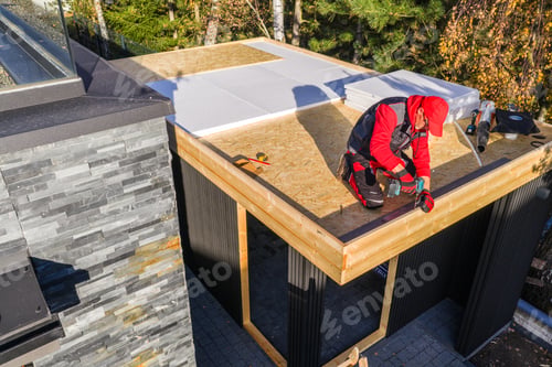 Preview: Construction Work on a Flat Roof Structure Near Trees