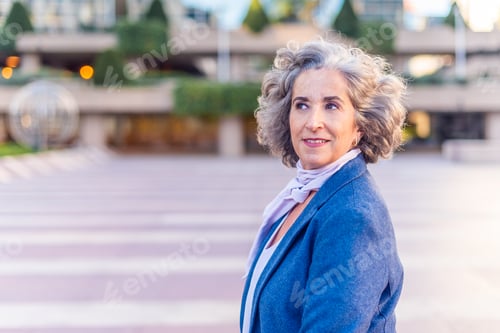 Preview: mature woman with grey hair, blue jacket and white scarf