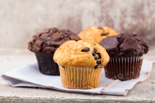 Preview: Homemade muffins with chocolate, vintage background.
