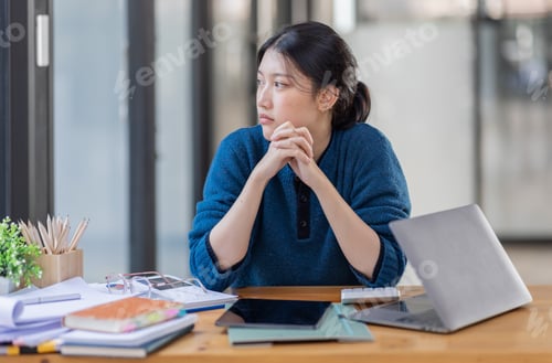 Preview: Portrait of tired young business Asian woman work with documents tax laptop computer in office. Sad,