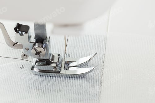 Preview: Sewing machine foot working on white fabric during crafting session