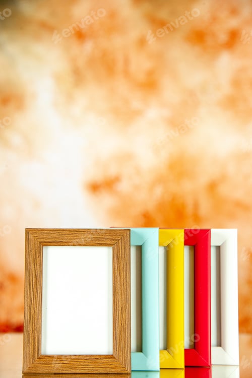 Preview: front view different picture frames with colored corners on light brown background picture portrait