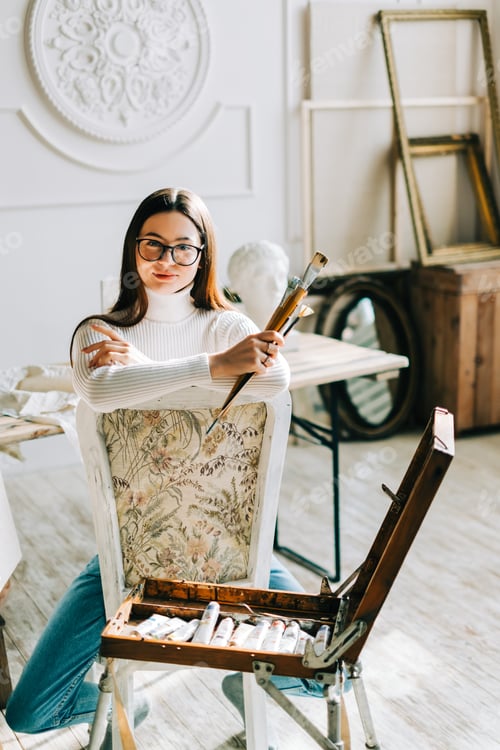 Preview: Young Woman Artist with Brushes in Art Studio
