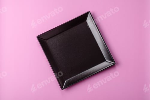 Preview: An empty round ceramic plate on a pink background as a kitchen utensil. An empty plate