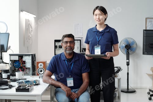 Preview: Smiling Colleagues Collaborating on Technology Project