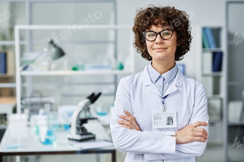 Preview: Young successful brunette female clinician or scientific expert in labcoat