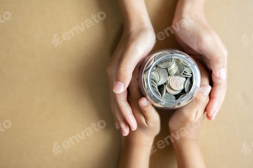 Preview: Child and Adult Hands Holding Jar of Coins