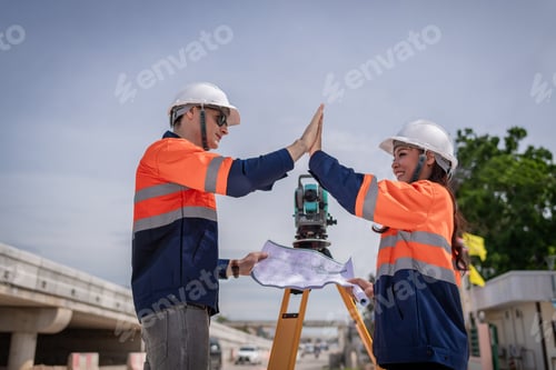 Preview: Engineers Surveyor wearing safety uniform ,helmet with equipment theodolite to measurement positioni