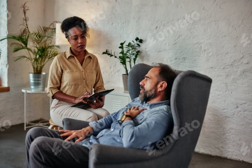 Preview: Mid age man having one counseling meeting with psychotherapist