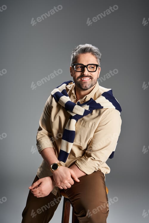 Preview: Handsome man showcases elegant fashion in stylish studio setting with confident pose