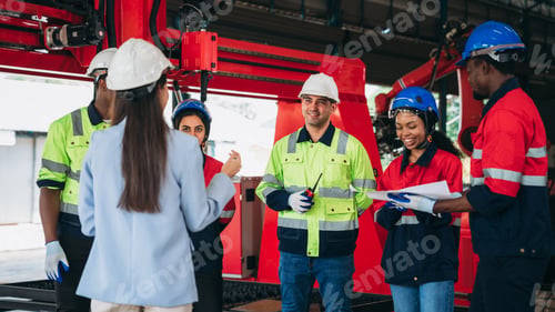 Preview: Engineers and foreman inspecting and meeting about the automated arms machine welding robots.
