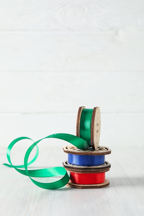 Preview: Skeins of ribbons on white wooden background