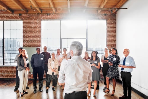 Preview: Senior businessman talking to a crowd